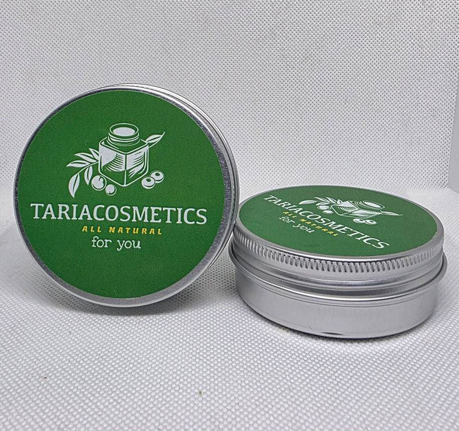 Two circular silver metal tins against a white background with the left tin positioned upright to show green lid with TariaCosmetics label.