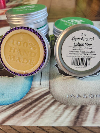 Shea Almond lotion bar and tins on a wooden surface
