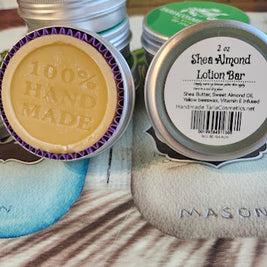 Shea Almond lotion bar and tins on a wooden surface