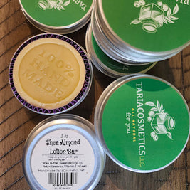 TariaCosmetics lotion bars and containers on a wooden surface