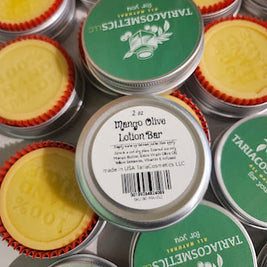 TariaCosmetics lotion bars with green labels and red cookie cups in aluminum tins.