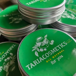 Stack of Tariacosmetics containers with green lids and silver bases.