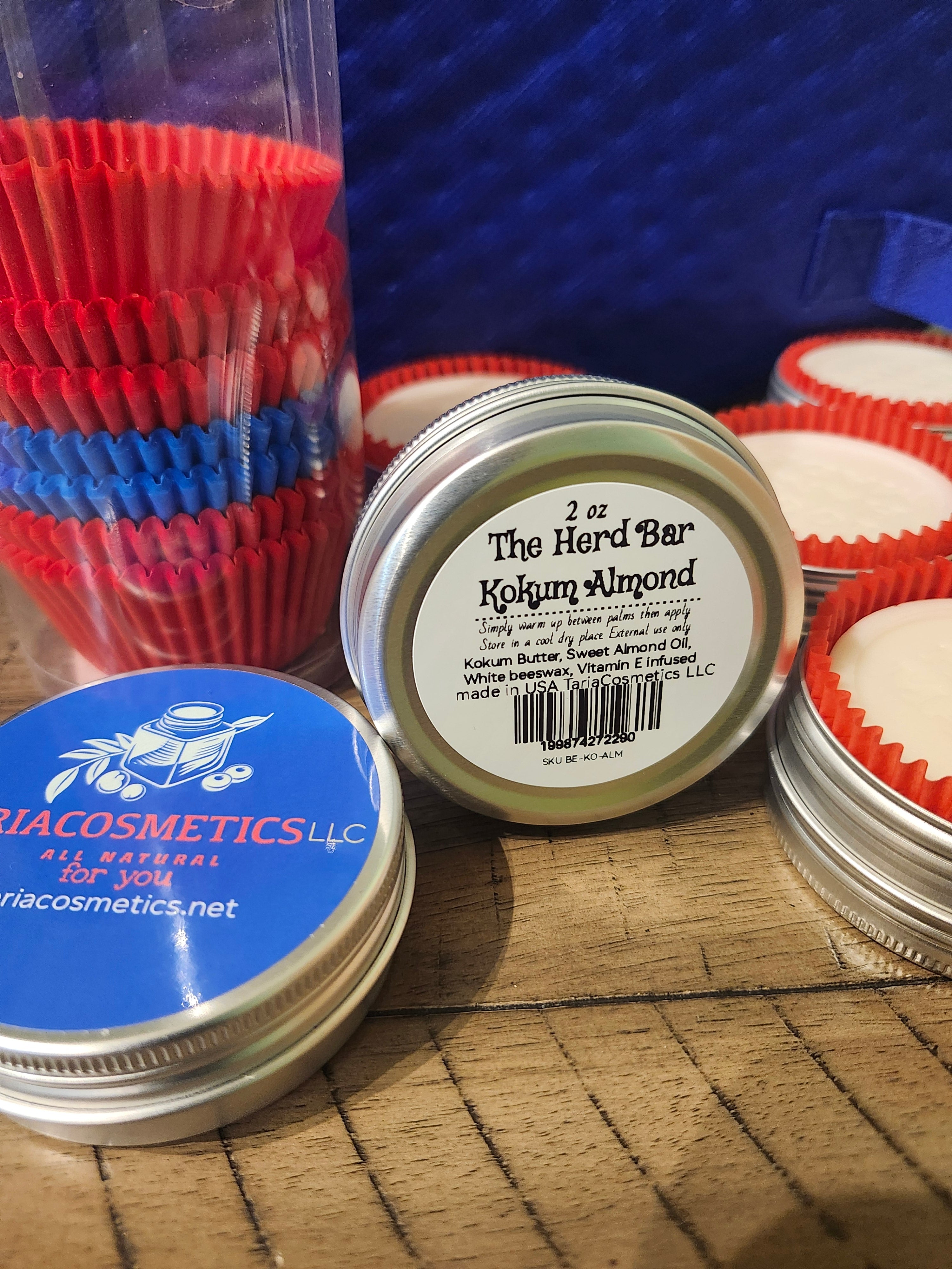 Jars of a cosmetic product with visible branding on a textured surface.