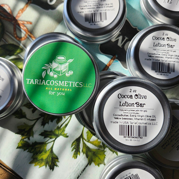 Multiple containers of TariaCosmetics on a surface with greenery