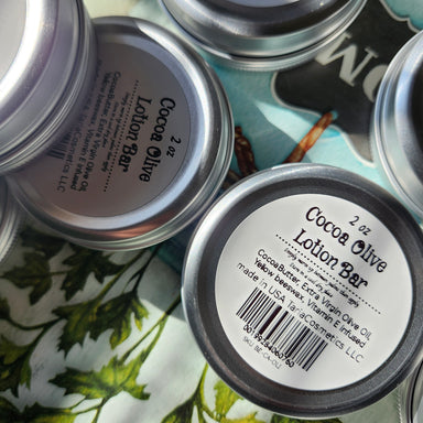 Cocoa Olive Lotion Bars with labels on a floral fabric background