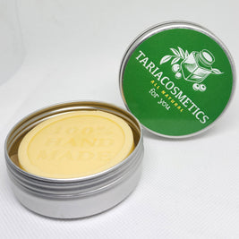 A round aluminum tin centered on a white background, featuring a green label with the TariaCosmetics branding.
