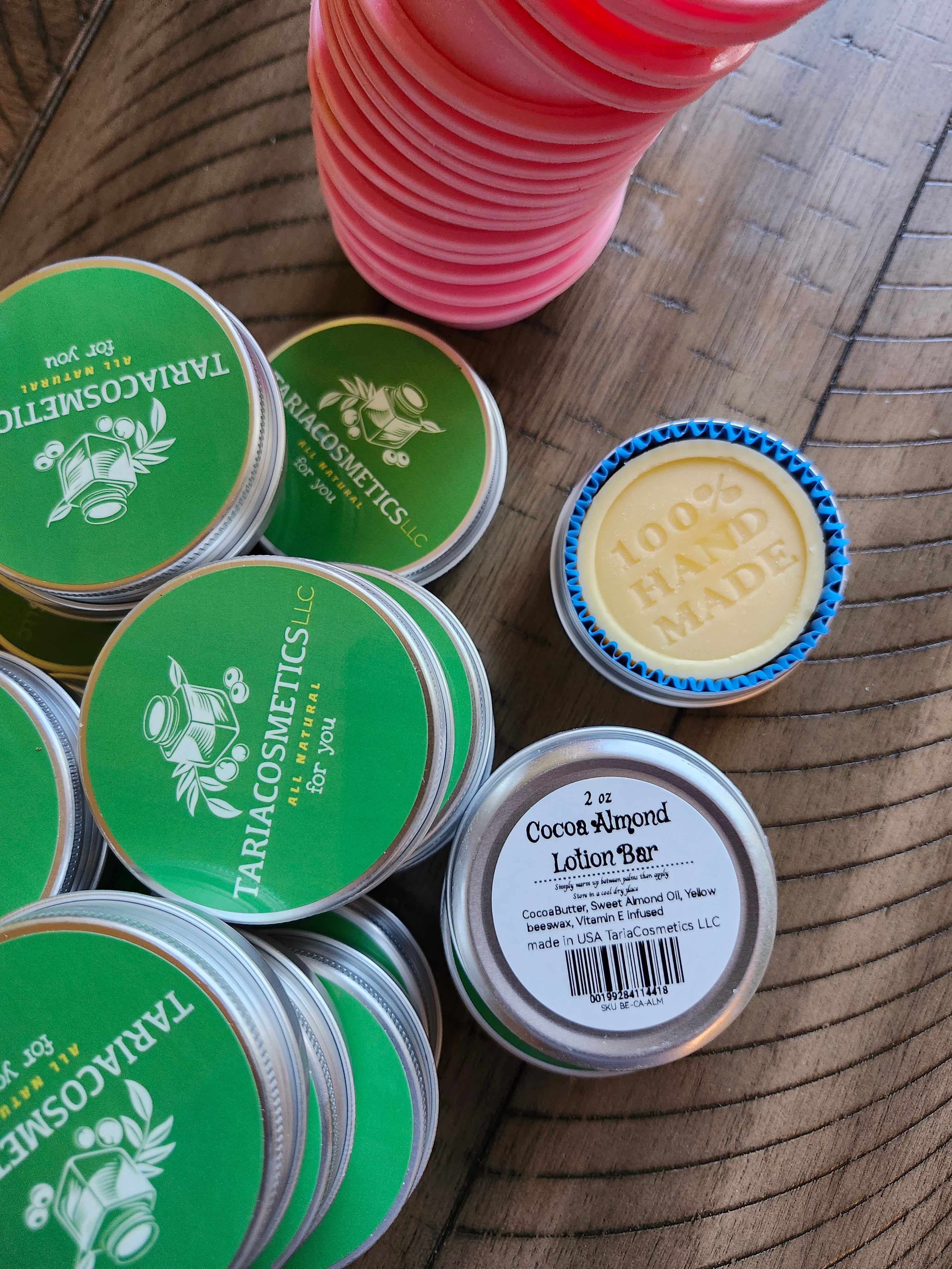 Collection of Tariacosmetics tins on a wooden surface