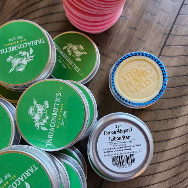 Collection of Tariacosmetics tins on a wooden surface