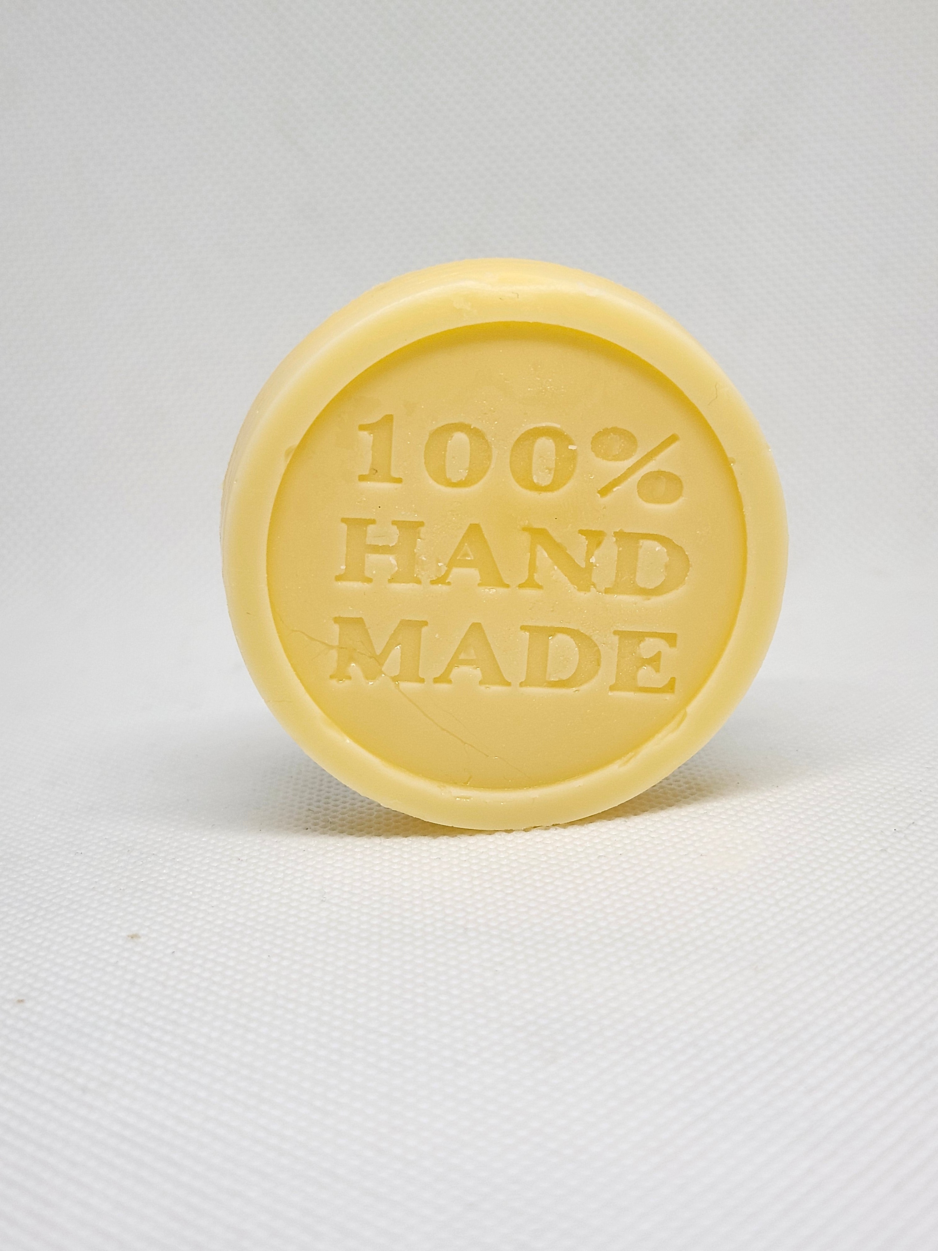 A tan, circular lotion bar with the words 
