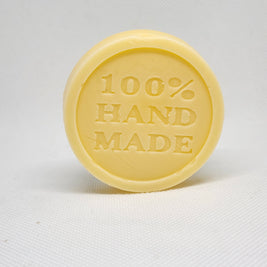 A tan, circular lotion bar with the words 